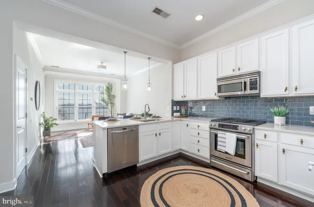 a kitchen with a stove top oven sink and cabinets