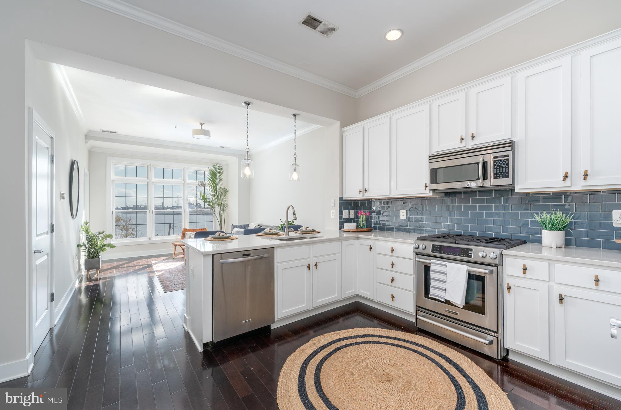 1500 Thames Street, Unit 401 Baltimore, MD 21231 - Photo 2 of 54 a kitchen with a stove top oven sink and cabinets