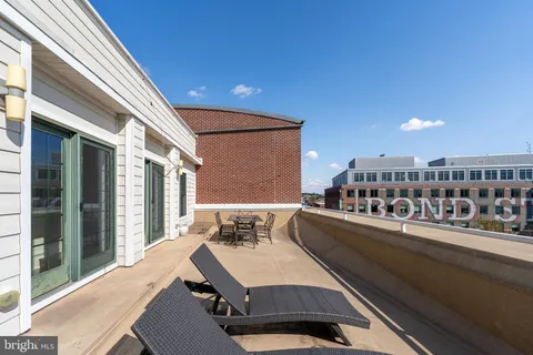 a view of a terrace with furniture and a kitchen