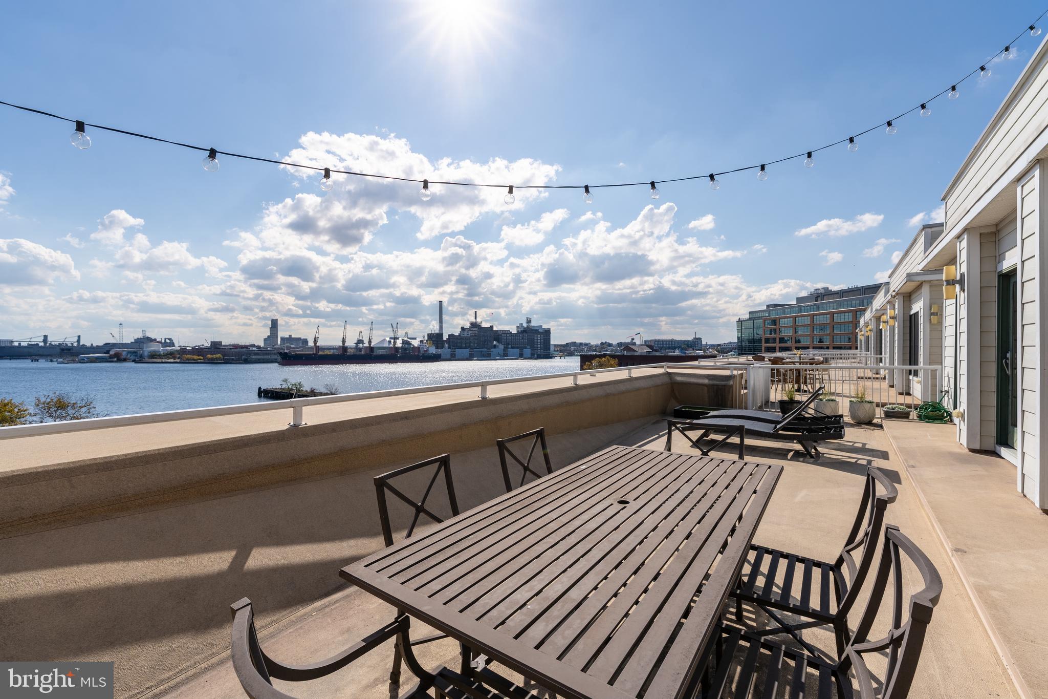 1500 Thames Street, Unit 401 Baltimore, MD 21231 - Photo 28 of 54 a view of a terrace with furniture and a kitchen