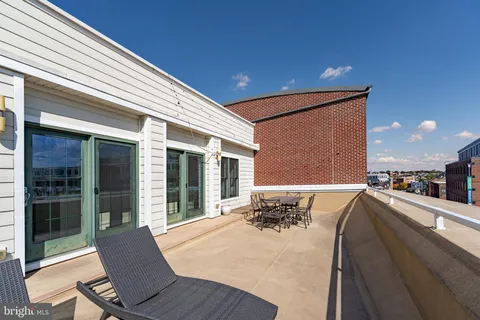 a view of a balcony with an outdoor seating