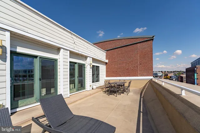 a view of a balcony with an outdoor seating