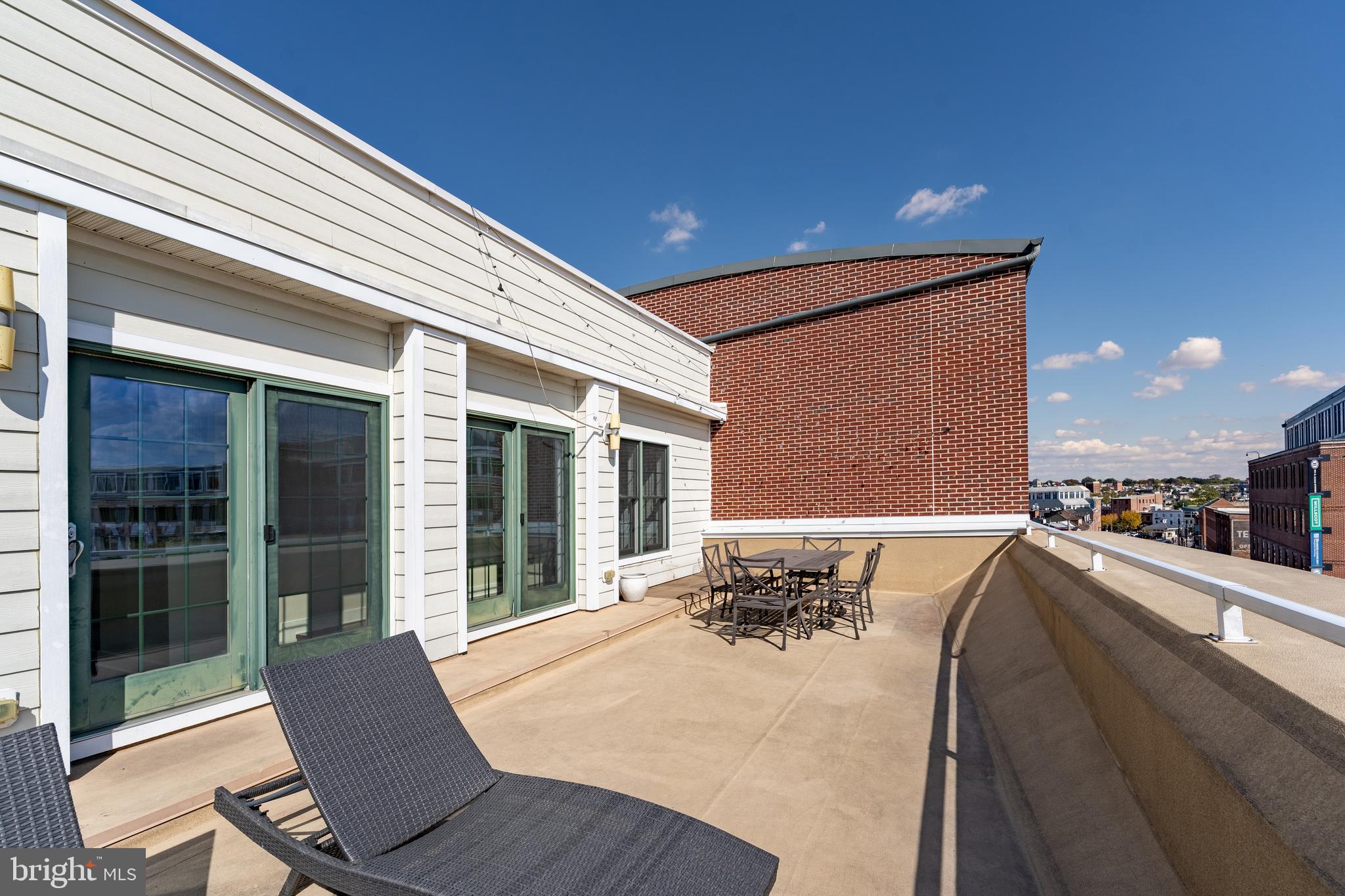 1500 Thames Street, Unit 401 Baltimore, MD 21231 - Photo 29 of 54 a view of a patio with table and chairs