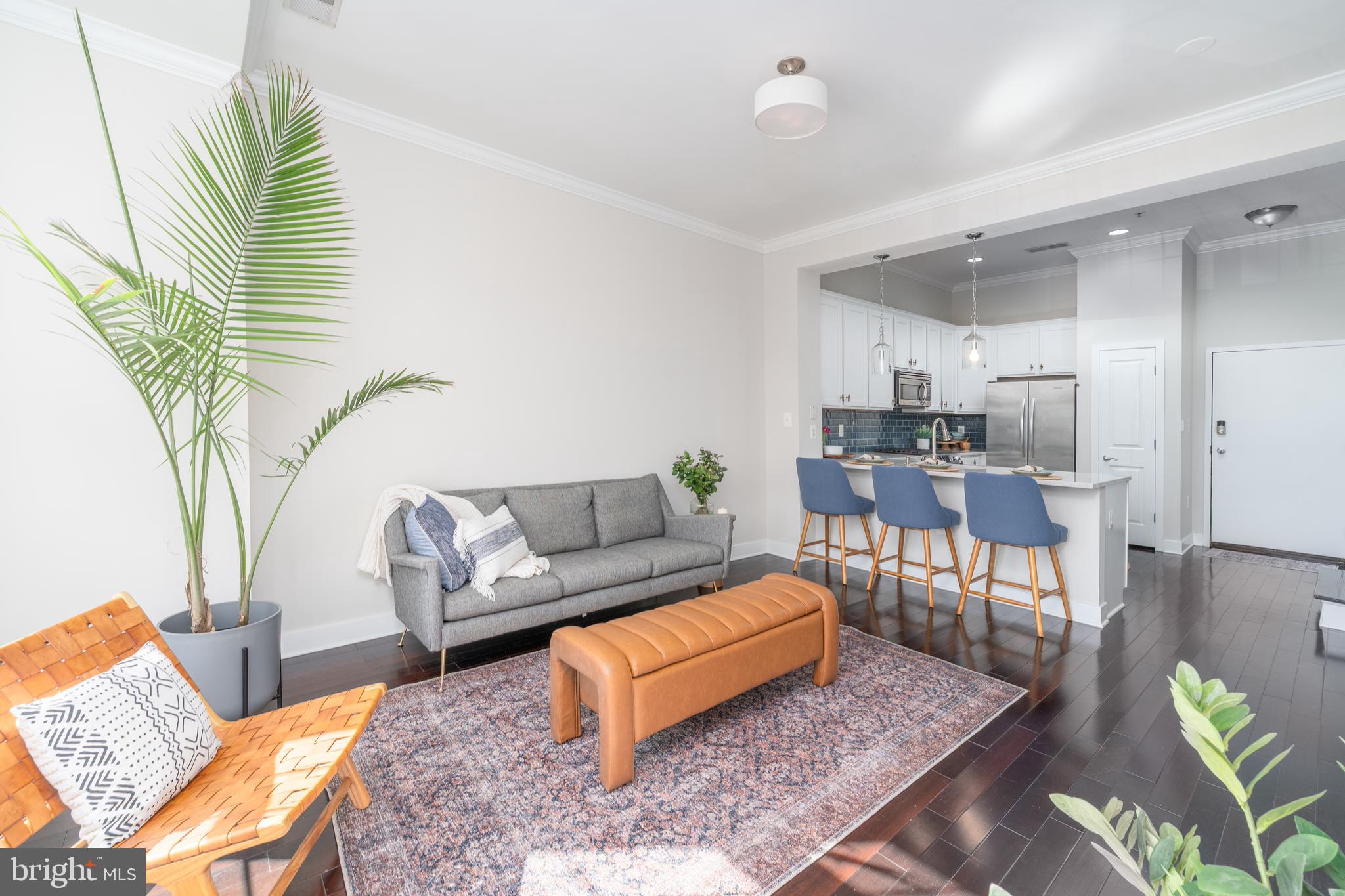 1500 Thames Street, Unit 401 Baltimore, MD 21231 - Photo 7 of 54 a living room with furniture and a wooden floor