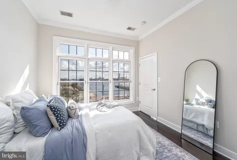 a bedroom with a bed and a large window