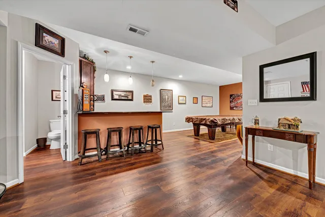 a view of a patio with chairs and table in a yard