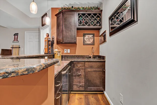 a view of a patio with a table chairs and a wooden fence