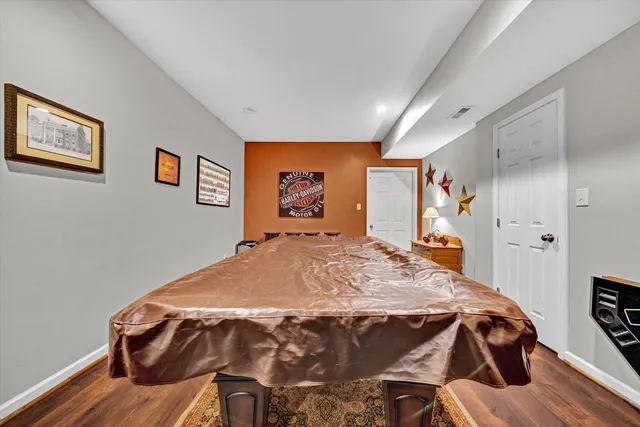 a view of a house with a big yard and large trees