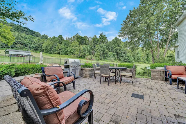 a view of a house with backyard and a garden
