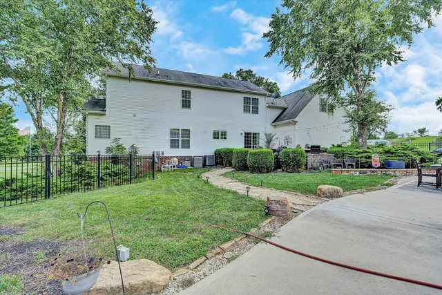 a view of a house with a yard covered with snow