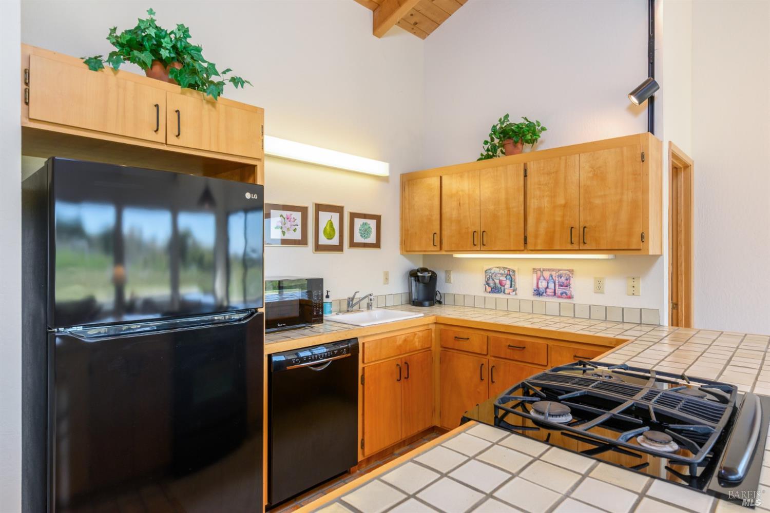 267 Sea Stack The Sea Ranch, CA 95497 - Photo 24 of 35 a kitchen with a sink stove and cabinets