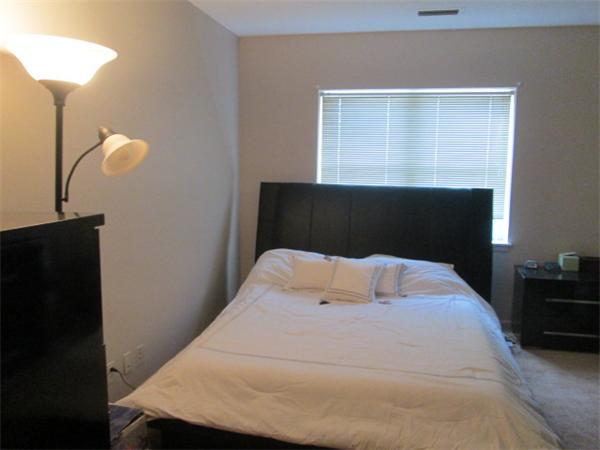 199 Lake Shore Road, Unit 4 Boston, MA 02135 - Photo 12 of 13 a bedroom with a bed and a night stand