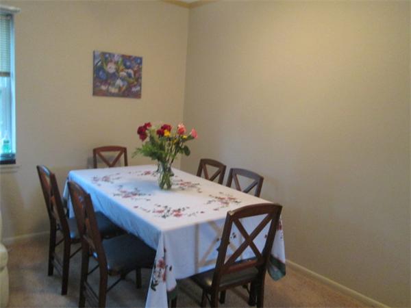 199 Lake Shore Road, Unit 4 Boston, MA 02135 - Photo 5 of 13 a view of a dining room with furniture and wooden floor