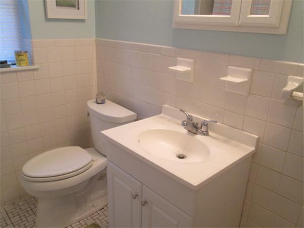 199 Lake Shore Road, Unit 4 Boston, MA 02135 - Photo 8 of 13 a bathroom with a sink a toilet and a mirror
