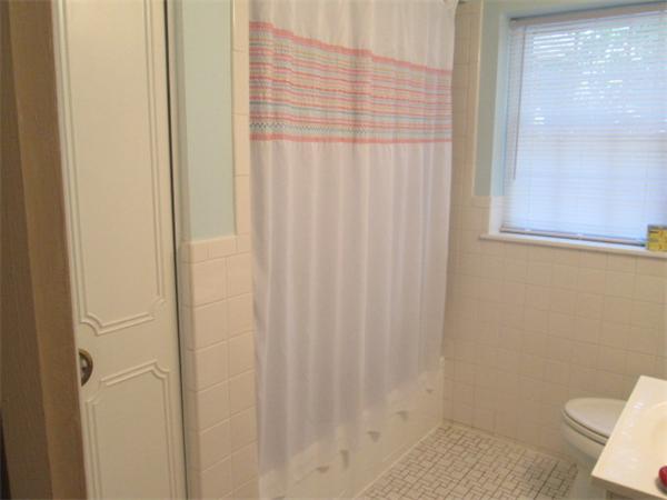 199 Lake Shore Road, Unit 4 Boston, MA 02135 - Photo 9 of 13 a bathroom with a shower curtain