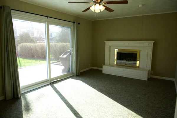 a view of a livingroom with an empty space and a fireplace