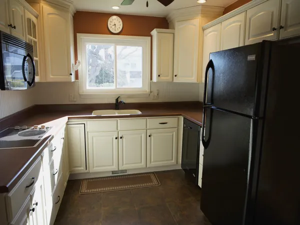 a kitchen with a refrigerator and a sink