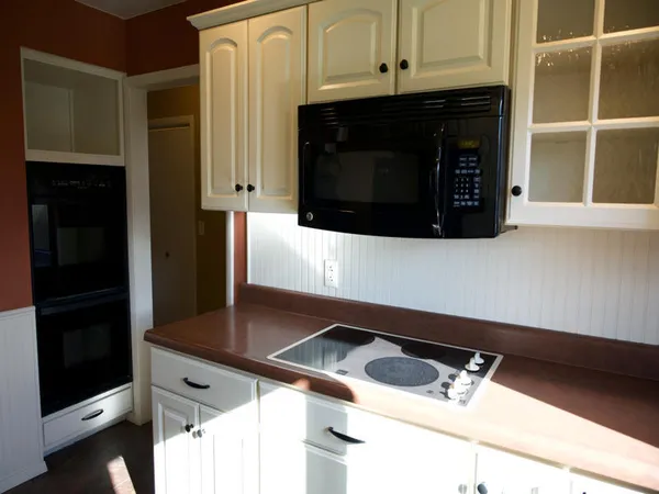 a close view of a microwave stove and cabinets