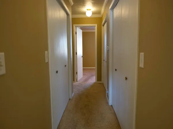 a view of a hallway with a door