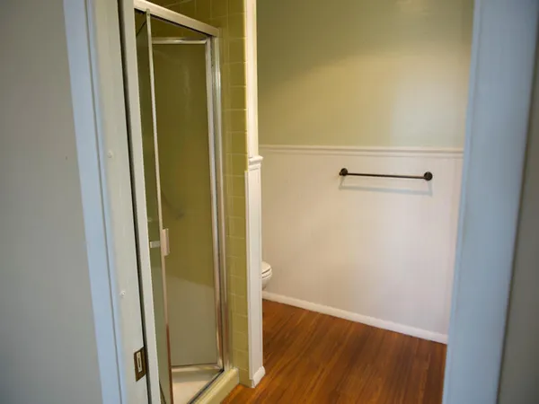 a view of a hallway with wooden floor