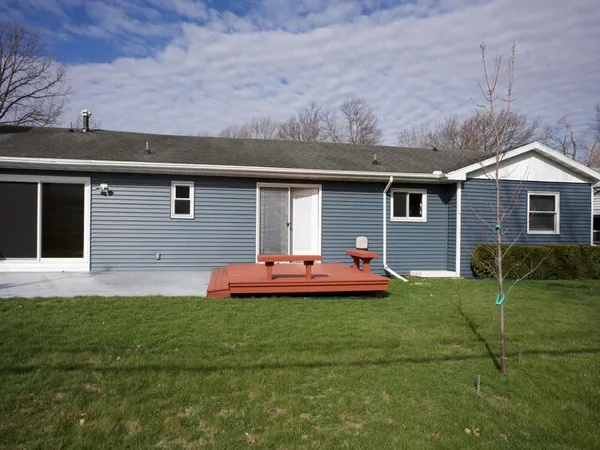 a front view of house with yard and outdoor seating