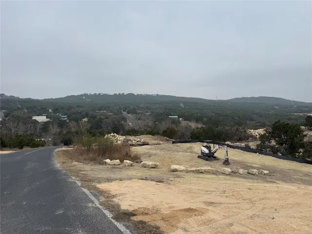 a view of a dry yard with mountains