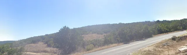 a view of a dry yard with mountain view