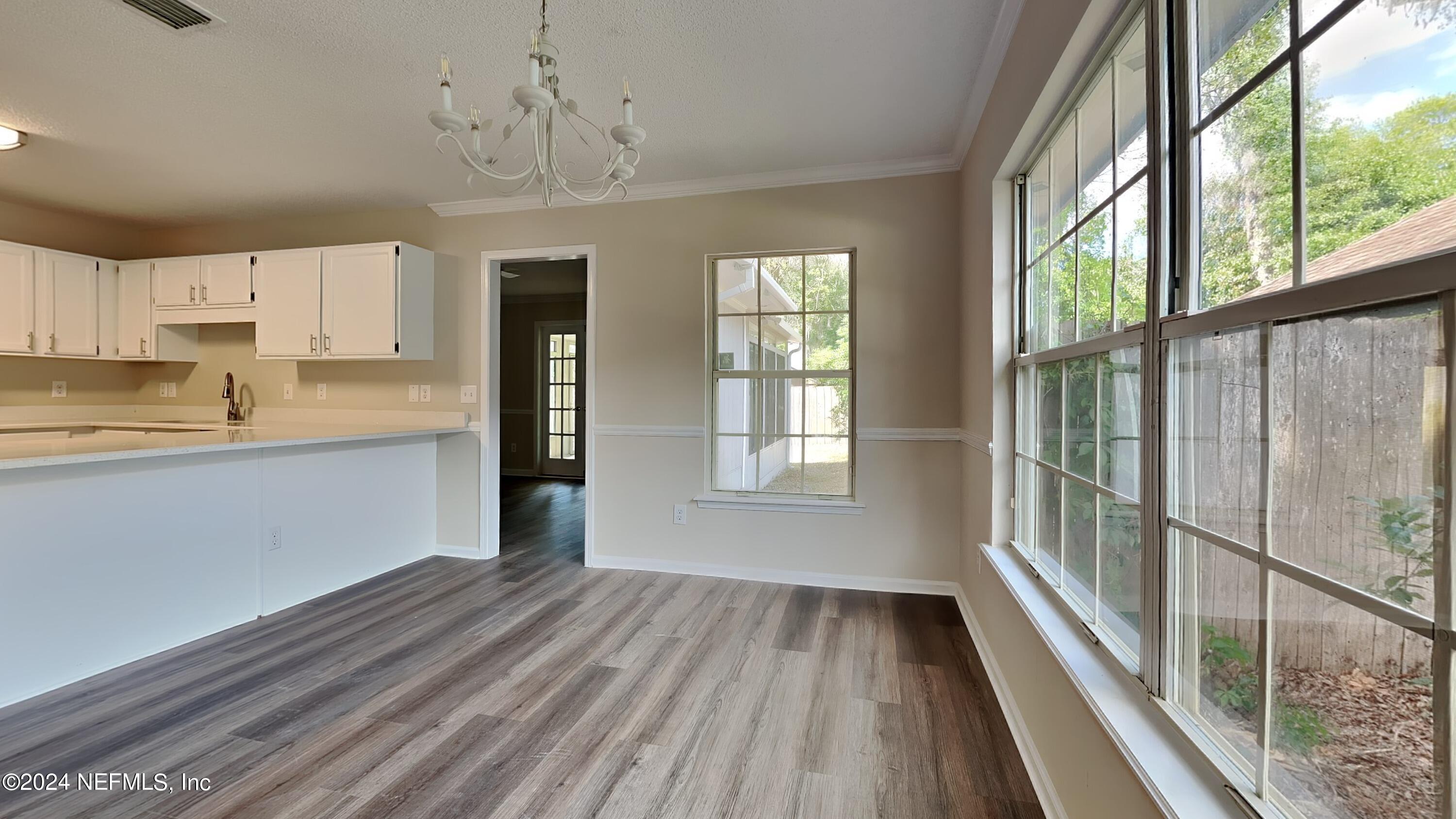 10951 Heathfield Road Jacksonville, FL 32225 - Photo 3 of 21 a view of a kitchen with wooden floor and electronic appliances