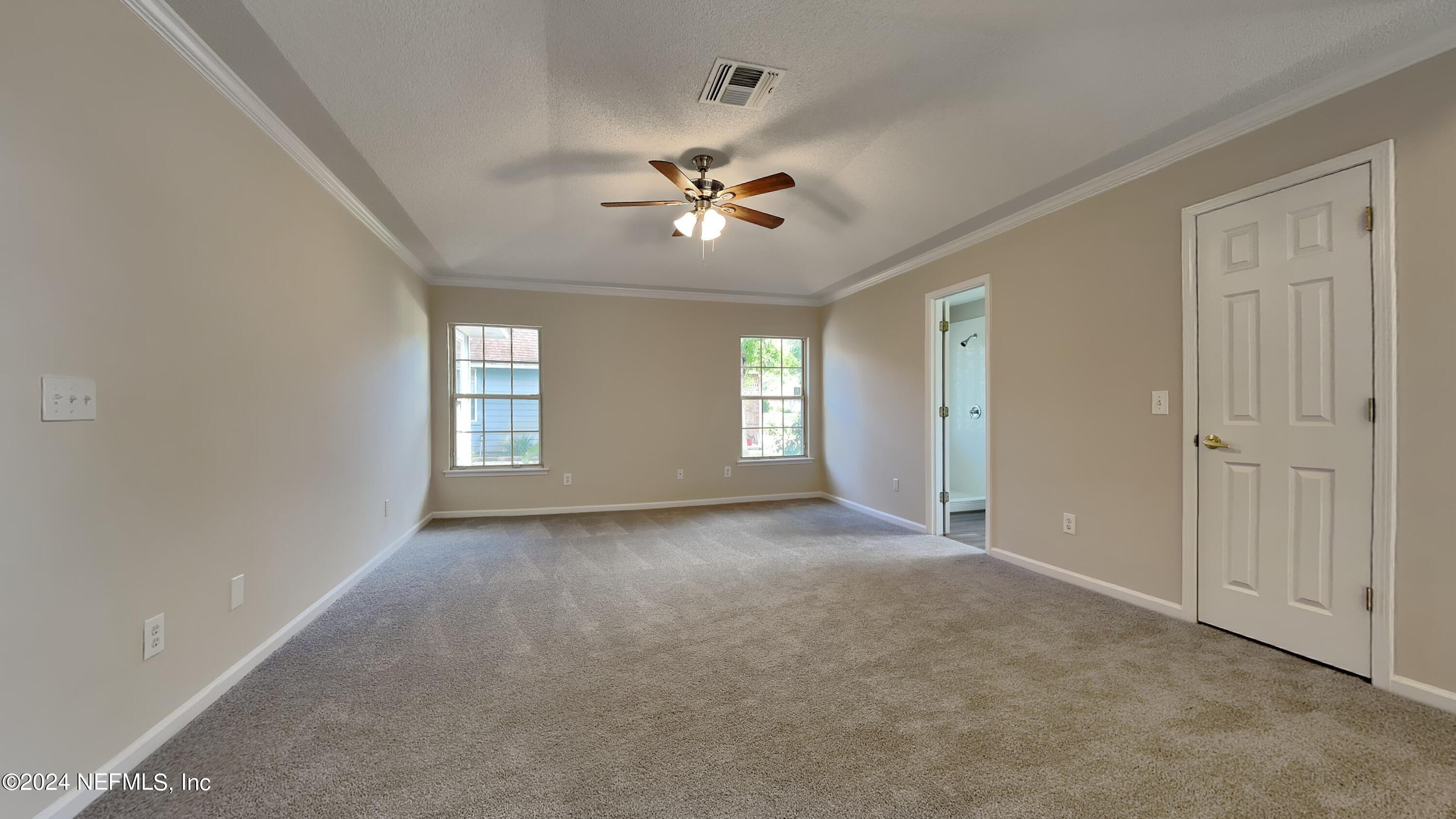 10951 Heathfield Road Jacksonville, FL 32225 - Photo 8 of 21 a view of a windows and chandelier fan in an empty room