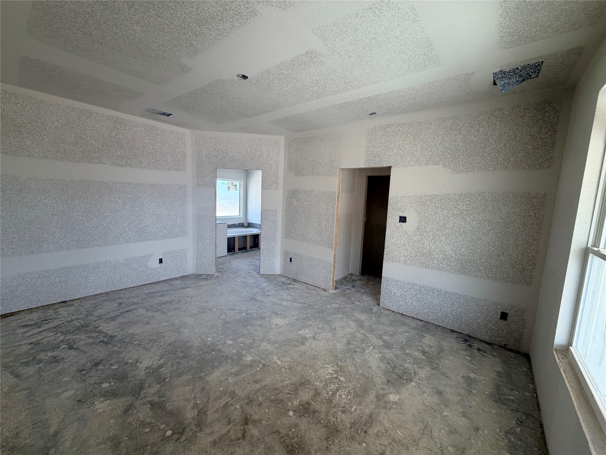 237 Lazy Lizzy Road Jarrell, TX 76537 - Photo 9 of 18 An unfinished primary suite awaits custom personalization with a tray ceiling and concrete subfloors.