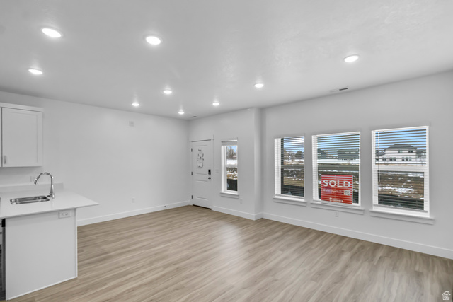3014 South 265th Street West Logan, UT 84321 - Photo 5 of 25 Open-concept living space with wood-finish flooring, recessed lighting, and multiple windows