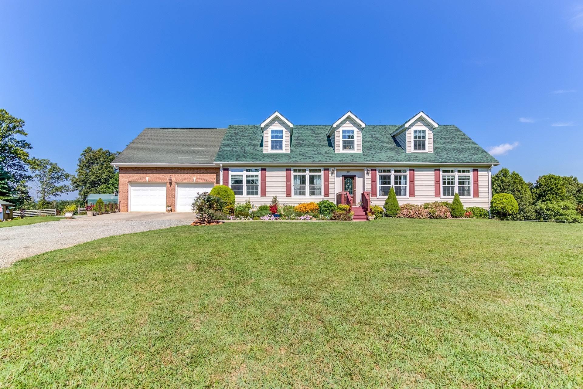 2494 Henry Road Ferrum, VA 24088 - Photo 2 of 60 a front view of a house with garden