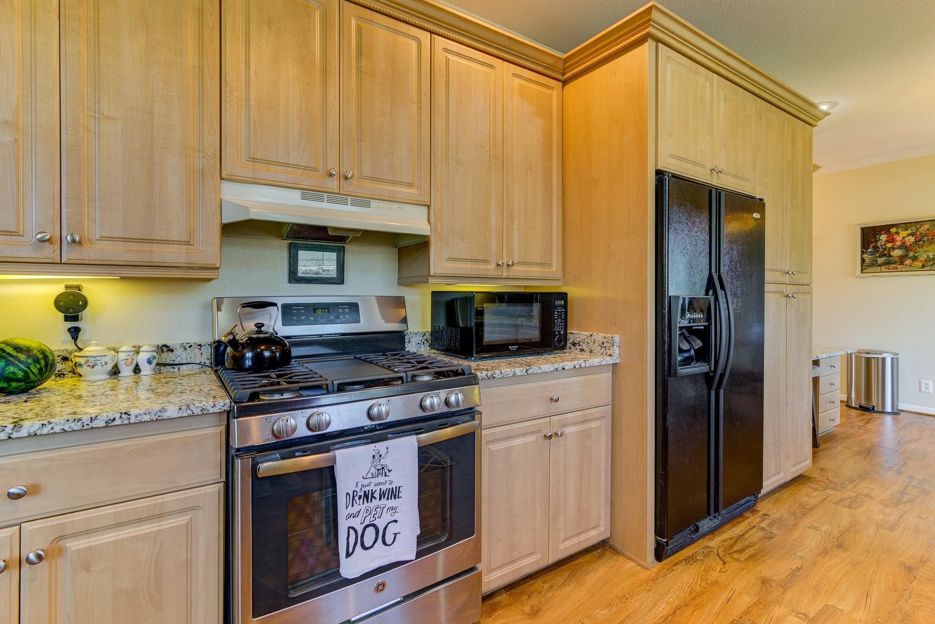 2494 Henry Road Ferrum, VA 24088 - Photo 14 of 60 a kitchen with stainless steel appliances granite countertop a stove a sink and a refrigerator