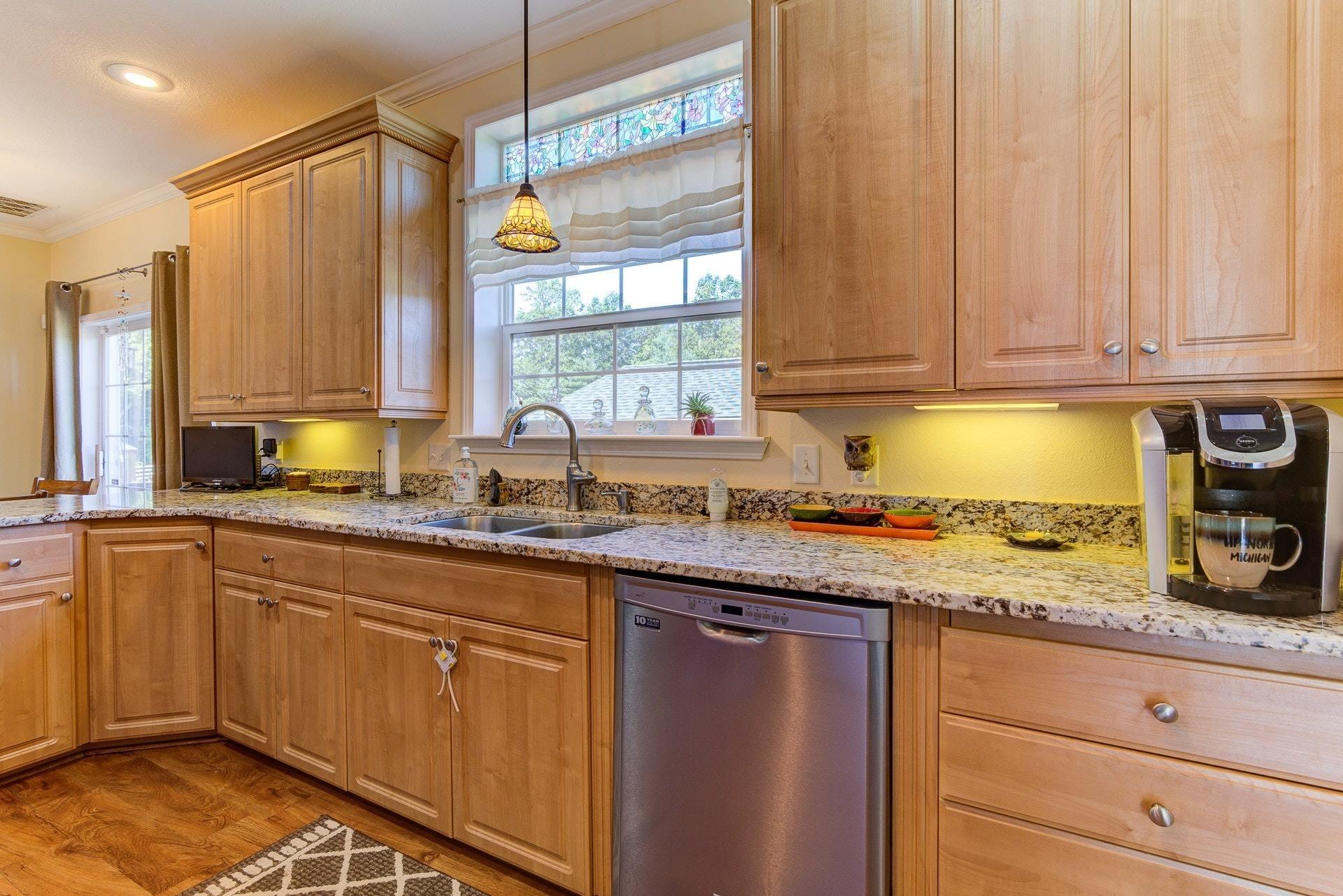 2494 Henry Road Ferrum, VA 24088 - Photo 15 of 60 a kitchen with stainless steel appliances granite countertop a sink a stove cabinets and wooden floor