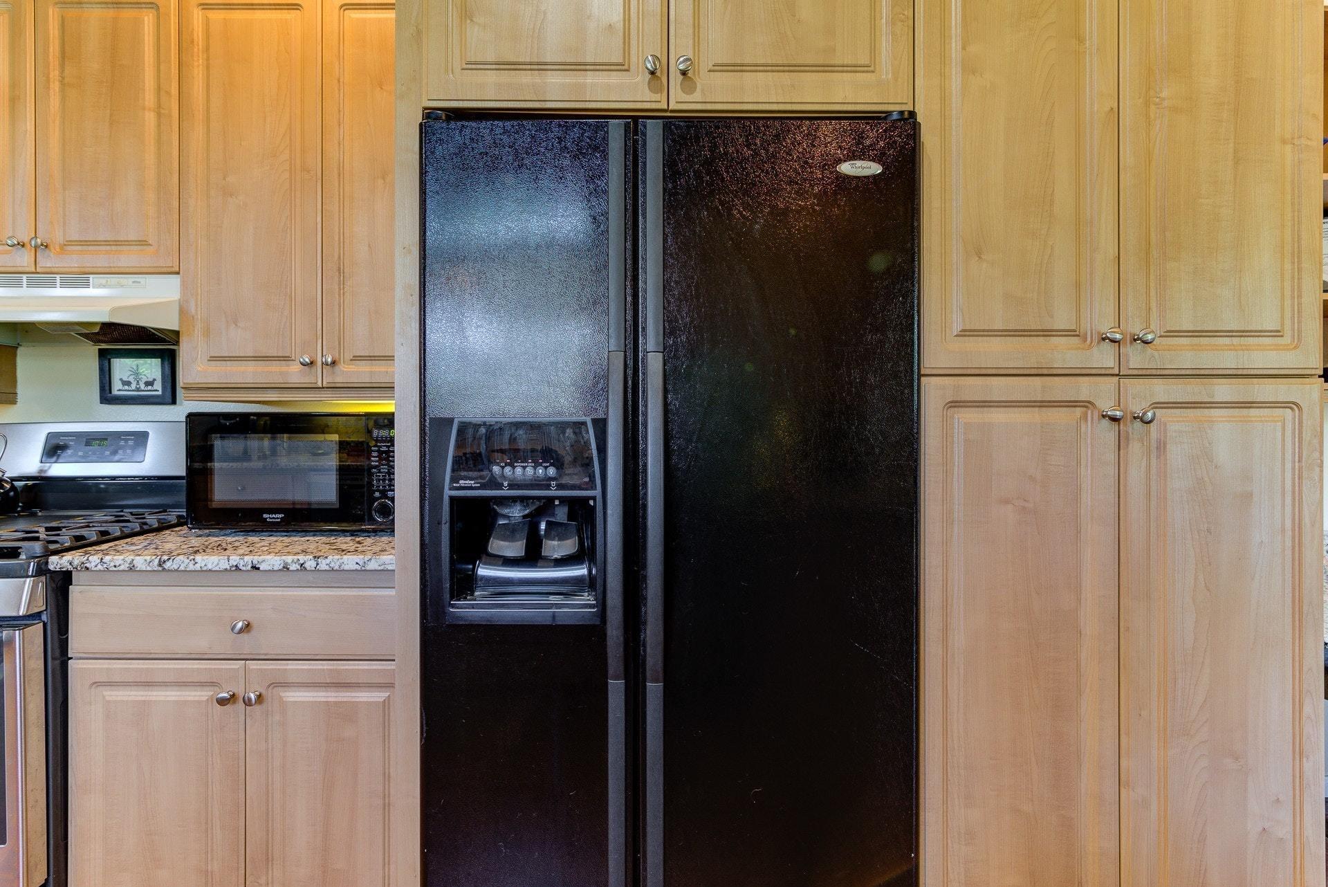 2494 Henry Road Ferrum, VA 24088 - Photo 16 of 60 a kitchen with a refrigerator a stove top oven a washer and dryer