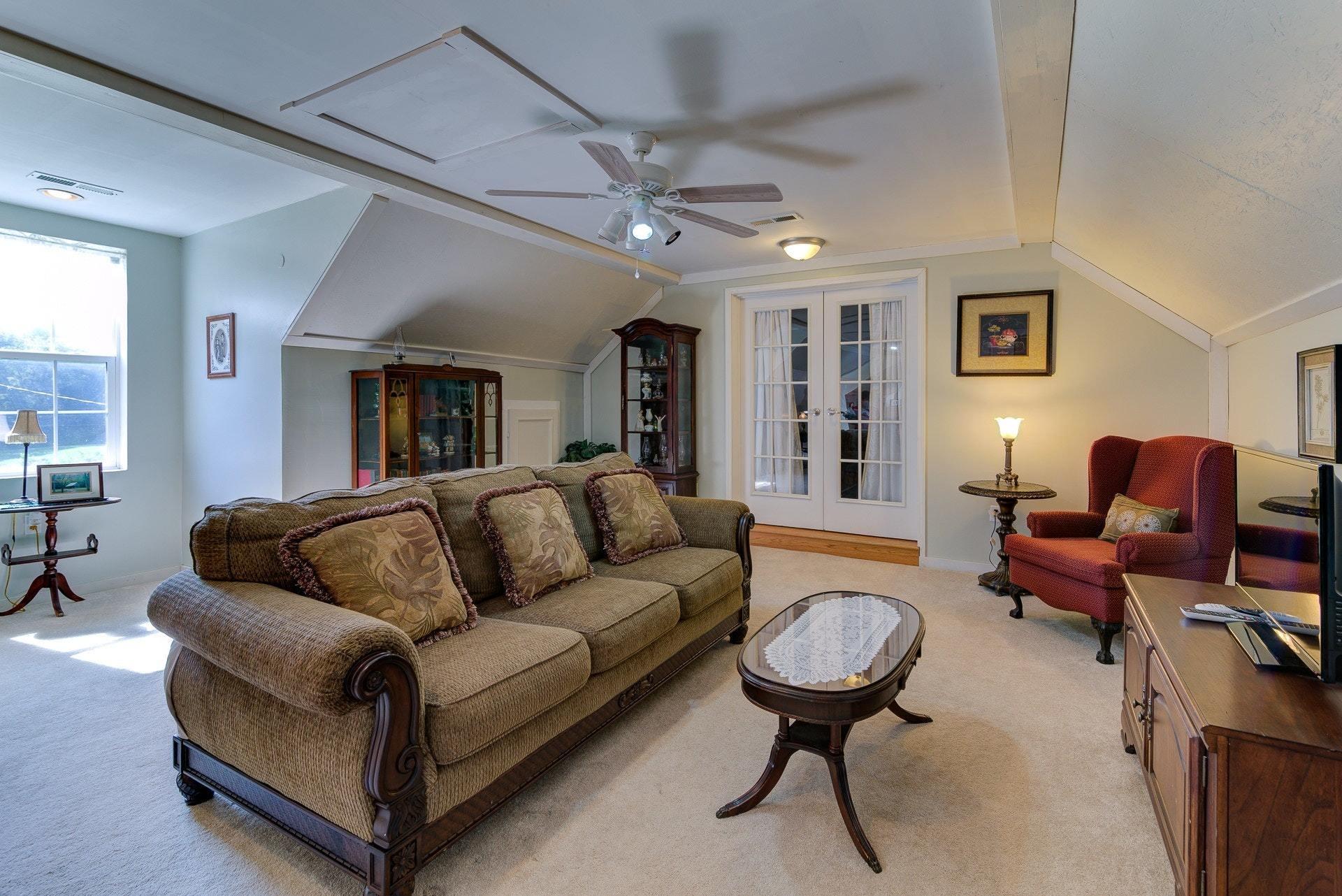 2494 Henry Road Ferrum, VA 24088 - Photo 30 of 60 a living room with furniture a ceiling fan and a rug