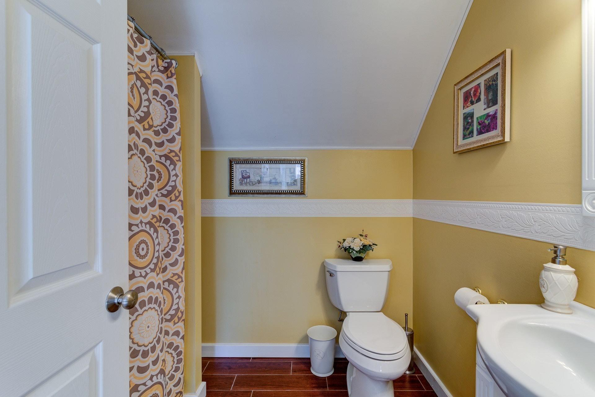 2494 Henry Road Ferrum, VA 24088 - Photo 35 of 60 a white toilet sitting next to a bathroom sink