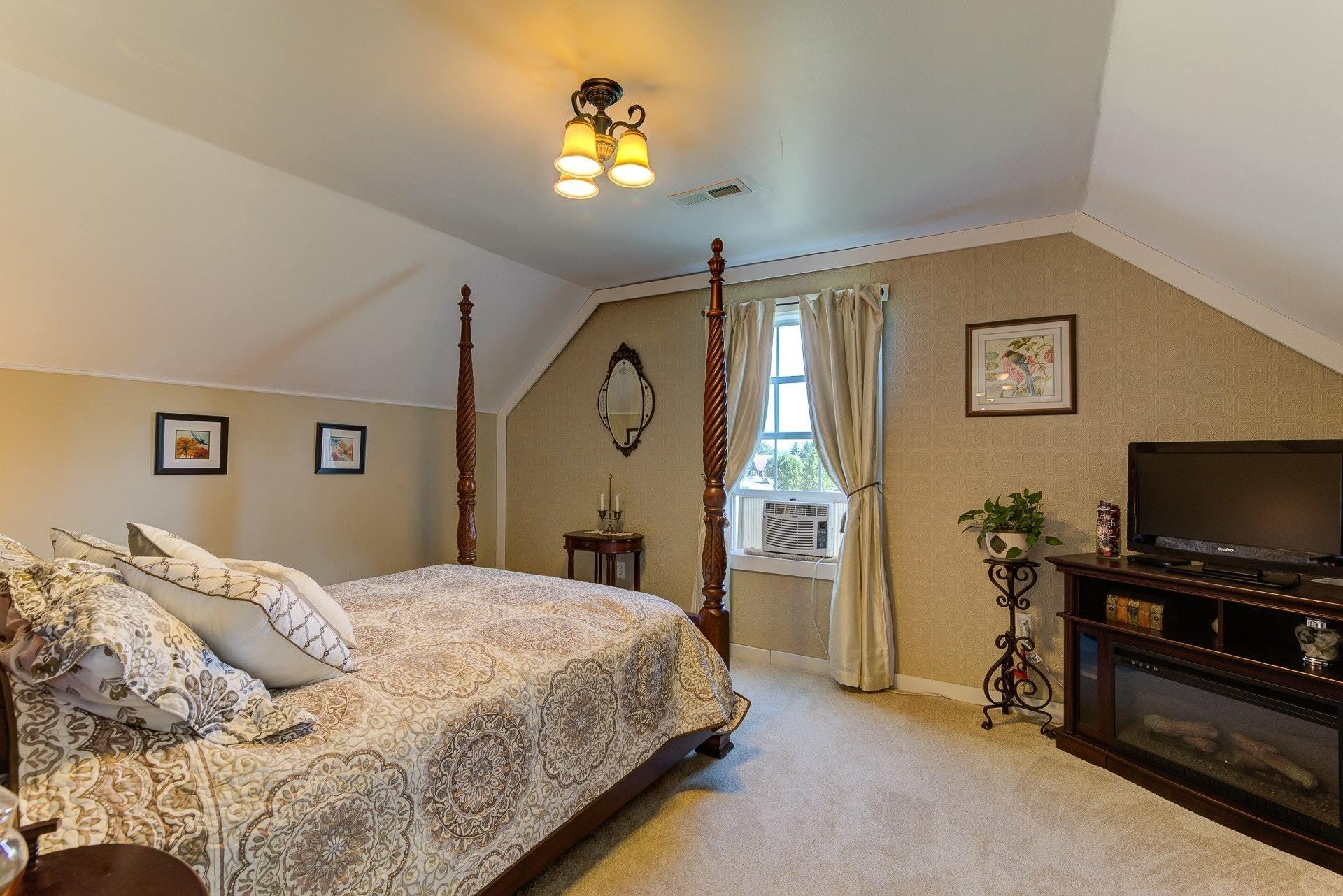 2494 Henry Road Ferrum, VA 24088 - Photo 36 of 60 a bedroom with a bed and a flat screen tv