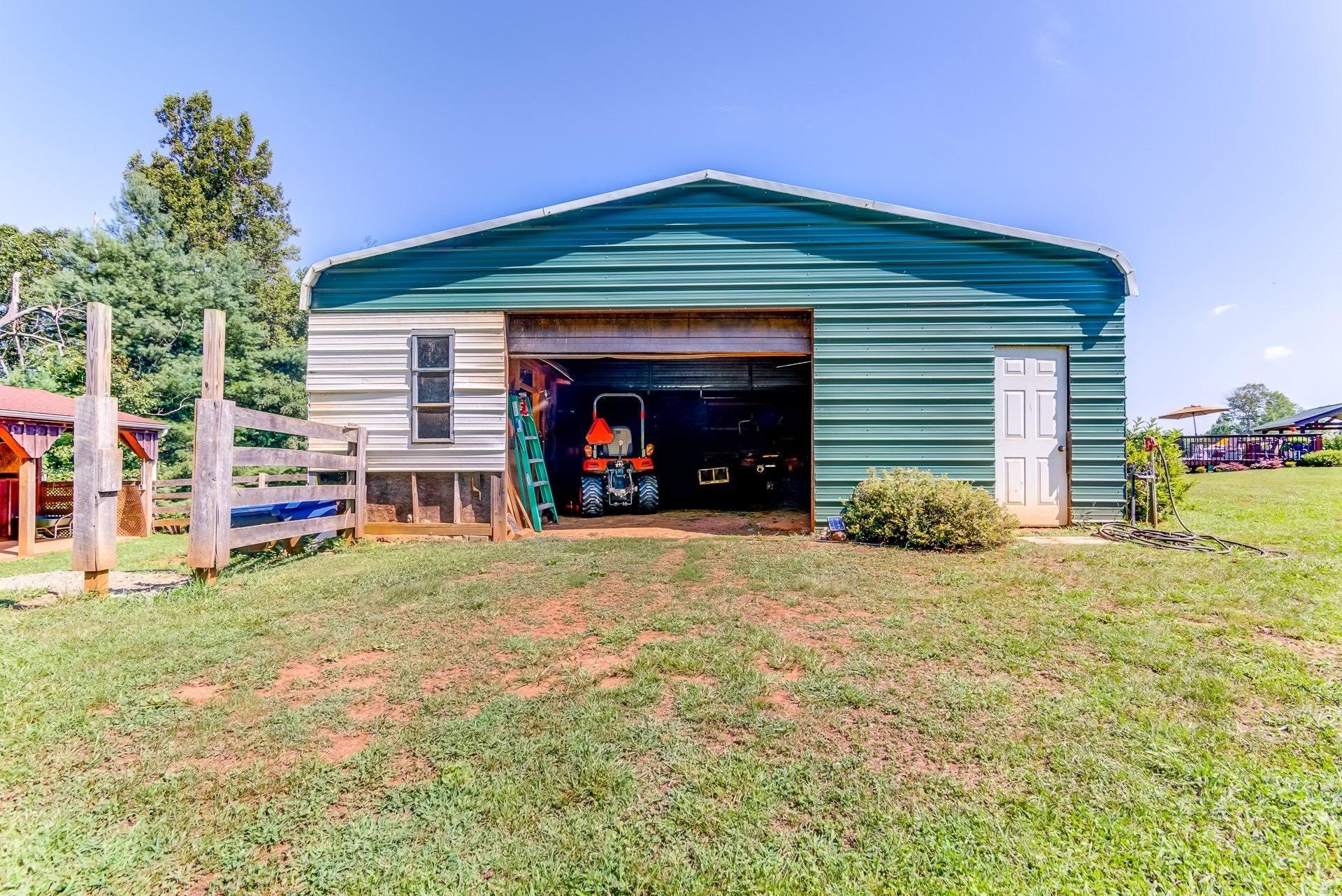 2494 Henry Road Ferrum, VA 24088 - Photo 52 of 60 a front view of a house with a yard and garage