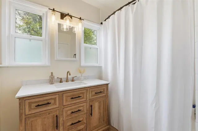 a backyard of a house with couches and potted plants