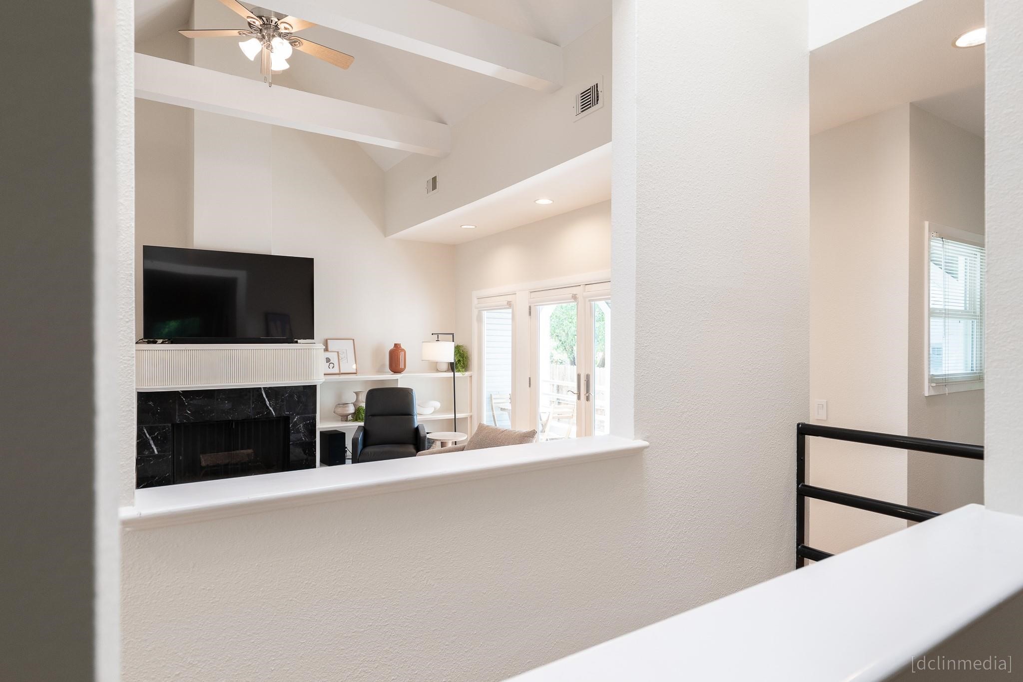 2002 Norfolk Street, Unit A Houston, TX 77098 - Photo 21 of 35 a living room with a fireplace and a flat screen tv