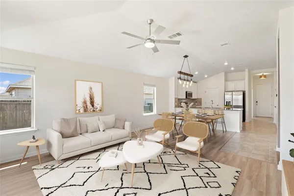 a living room with furniture and kitchen view