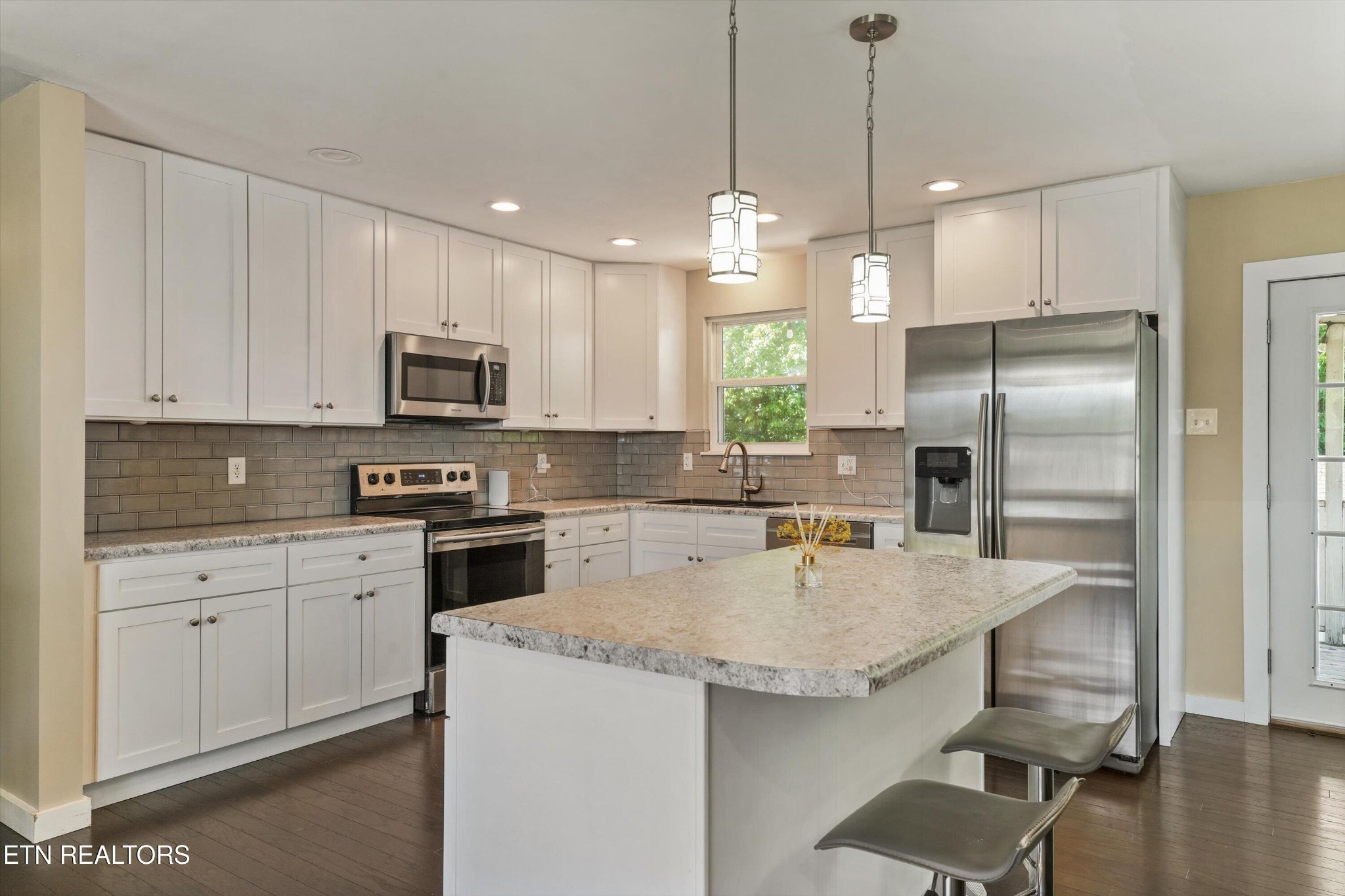 7613 Fall Wind Court Powell, TN 37849 - Photo 10 of 38 a kitchen with a center island appliances and cabinets