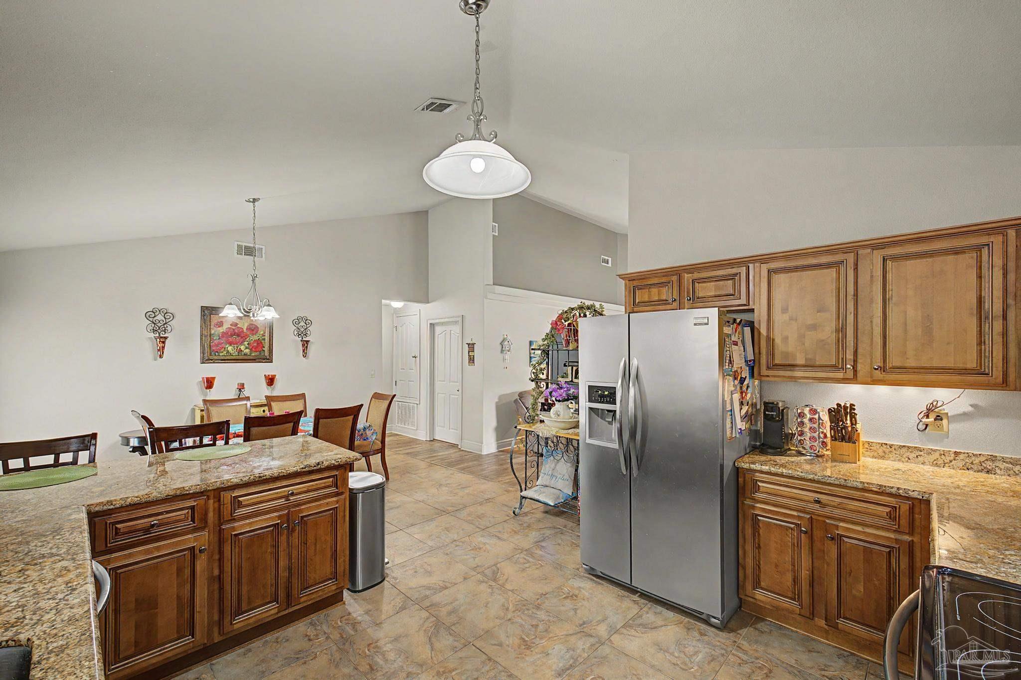 5461 Tucker Circle Pace, FL 32571 - Photo 15 of 52 a kitchen with stainless steel appliances granite countertop a refrigerator a stove a sink and a refrigerator