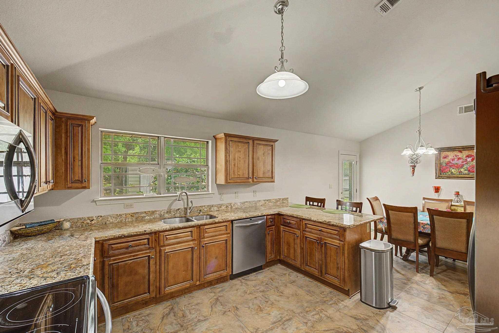 5461 Tucker Circle Pace, FL 32571 - Photo 16 of 52 a kitchen with a sink stove and cabinets