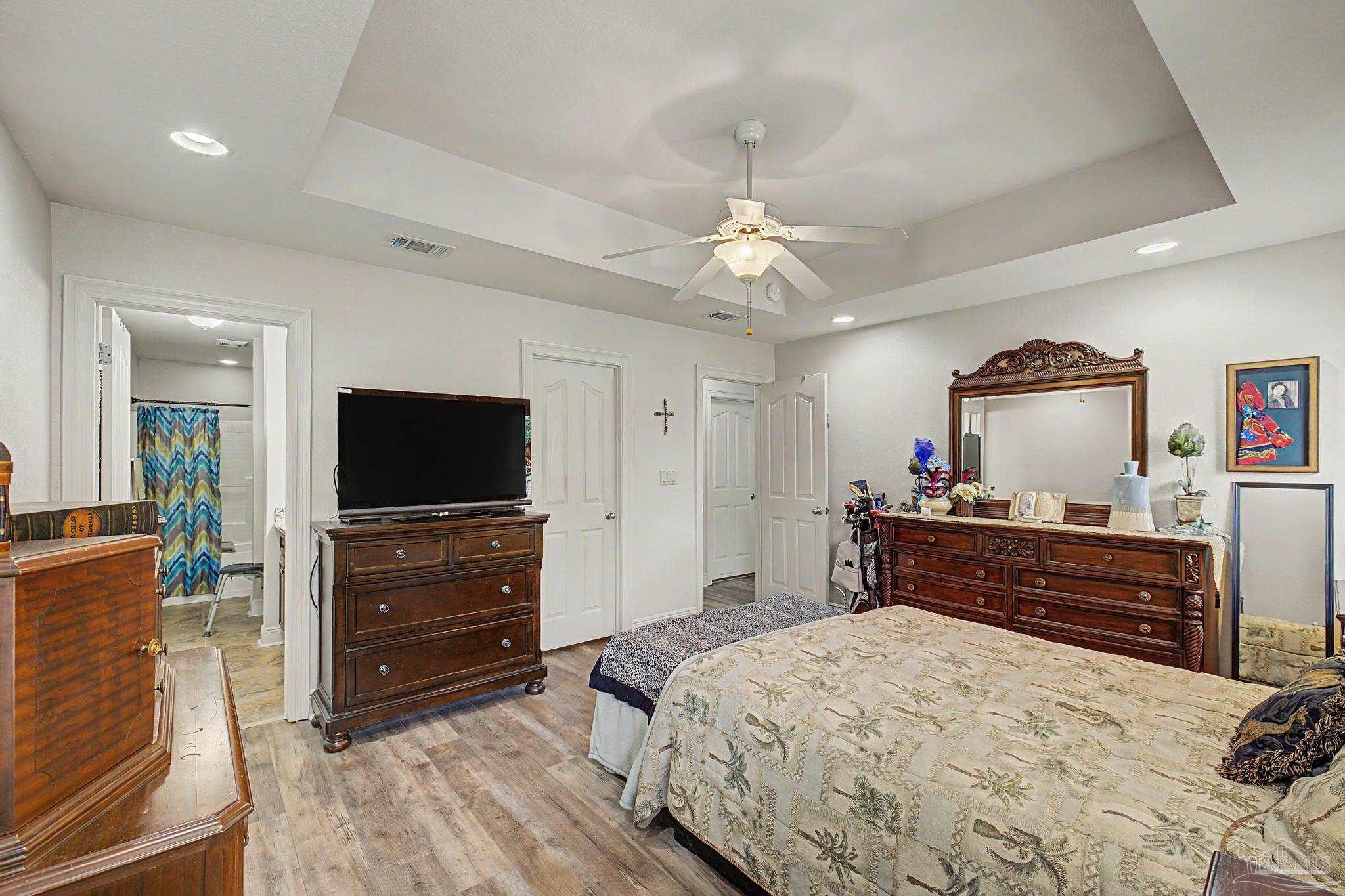5461 Tucker Circle Pace, FL 32571 - Photo 20 of 52 a bedroom with a bed and wooden floor