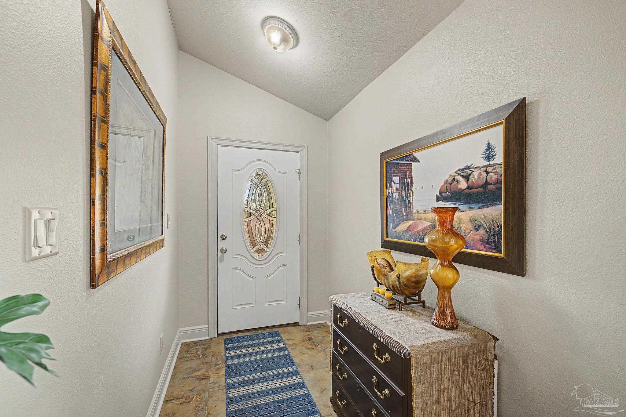 5461 Tucker Circle Pace, FL 32571 - Photo 2 of 52 a view of a hallway with paintings on the wall
