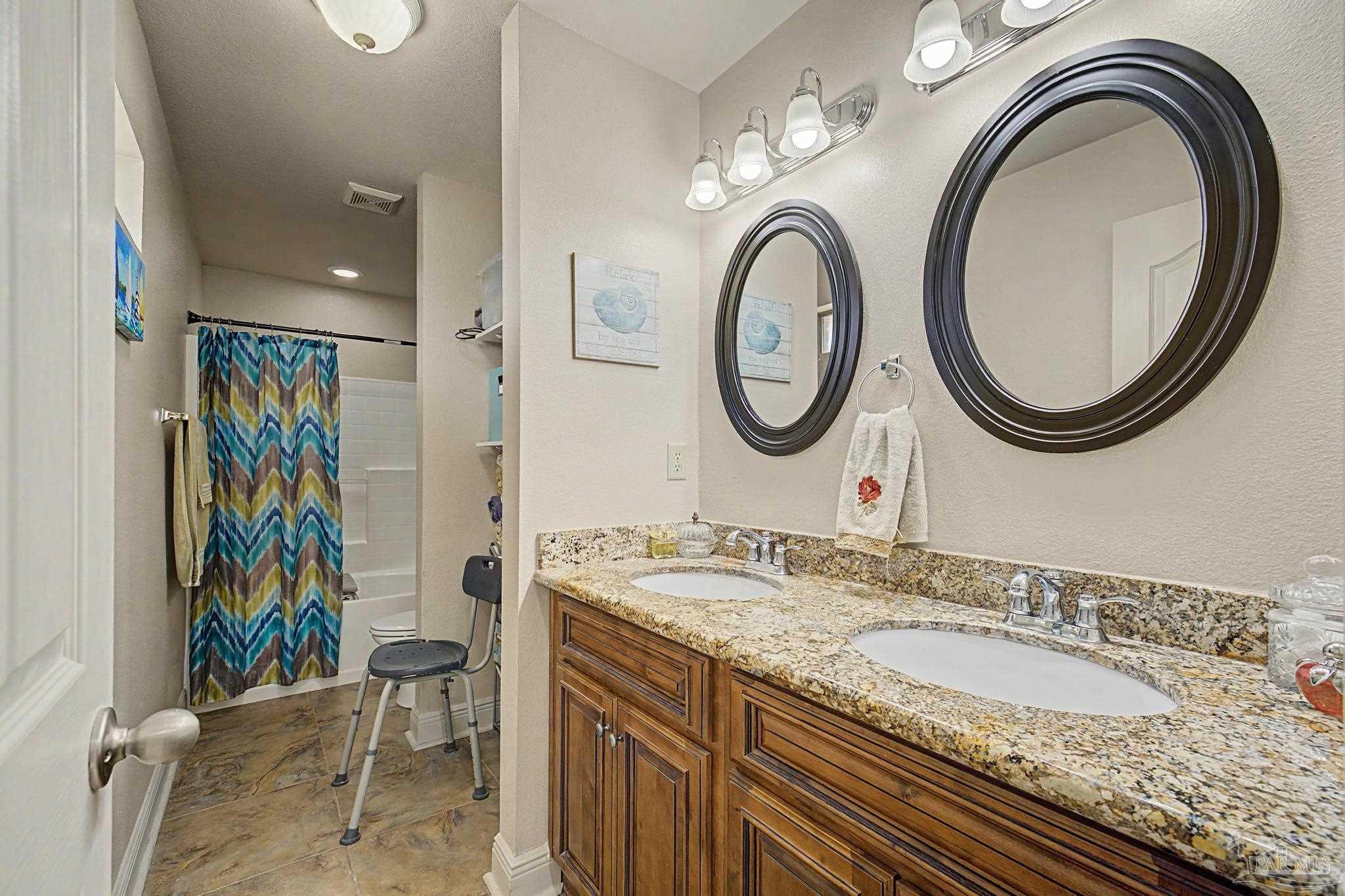 5461 Tucker Circle Pace, FL 32571 - Photo 21 of 52 a bathroom with a granite countertop double vanity sink and a mirror