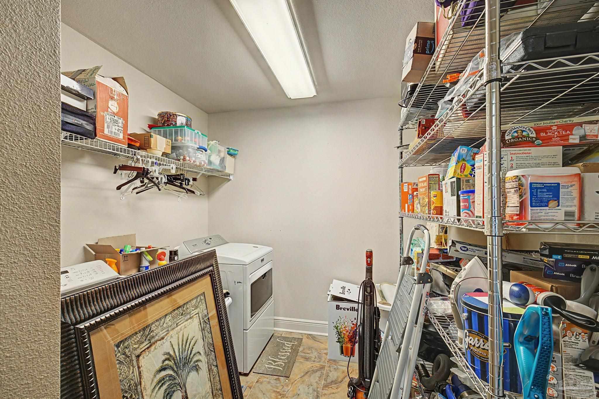 5461 Tucker Circle Pace, FL 32571 - Photo 23 of 52 a view of walk in closet with clothes and shoes
