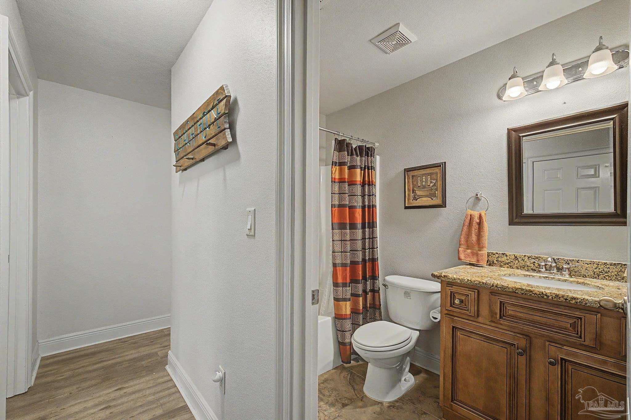 5461 Tucker Circle Pace, FL 32571 - Photo 25 of 52 a bathroom with a toilet a sink and a shower
